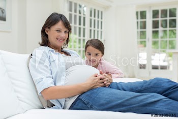 Portrait happy pregnant mother and daughter