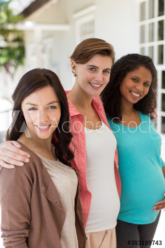 Portrait happy pregnant women friends