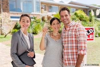 Portrait happy realtor and couple with keys outside new house