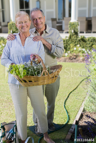 Portrait happy senior couple gardening