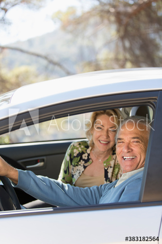 Portrait happy senior couple inside car