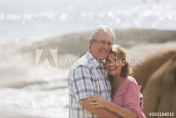 Portrait happy senior couple on beach