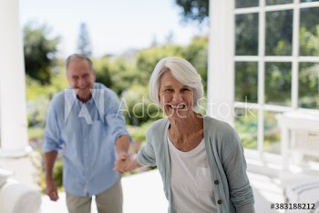 Portrait happy senior couple on patio