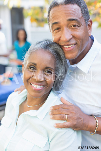 Portrait happy senior couple on patio