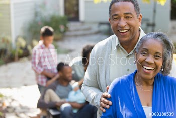 Portrait happy senior couple on patio with family