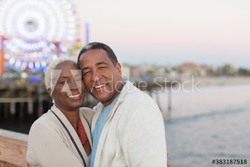 Portrait happy senior couple on Santa Monica Pier, Los Angeles, USA