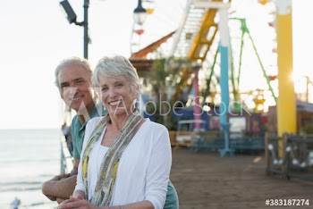 Portrait happy senior couple on Santa Monica Pier, Los Angles, USA