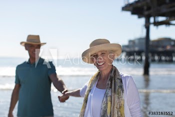 Portrait happy senior couple on sunny beach