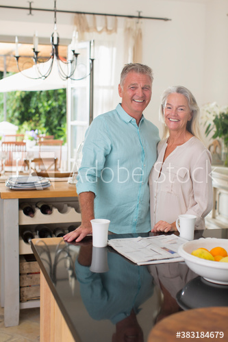Portrait happy senior couple with coffee in kitchen