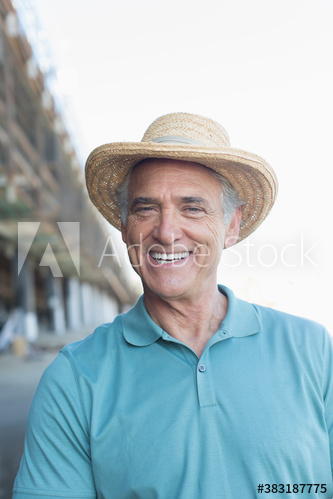 Portrait happy senior man in sun hat