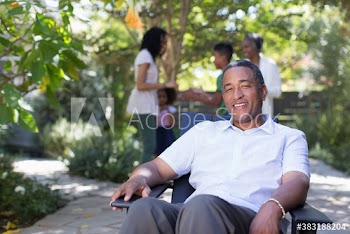 Portrait happy senior man on patio with family
