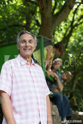 Portrait happy senior man with family in park