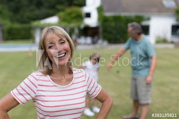 Portrait happy senior woman in backyard with family