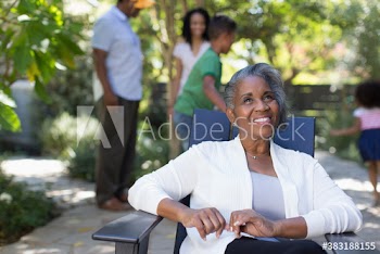 Portrait happy senior woman with family on patio