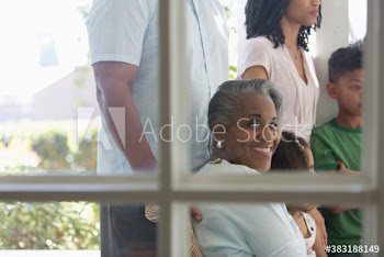 Portrait happy senior woman with family on porch