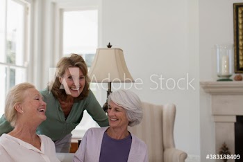Portrait happy senior women friends in living room