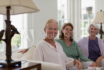 Portrait happy senior women friends in living room