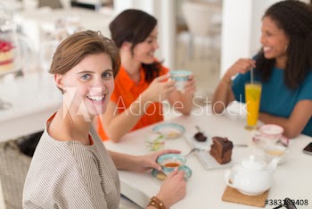 Portrait happy woman drinking tea with friends