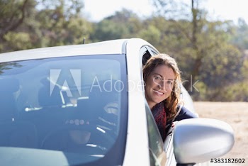 Portrait happy woman driving car