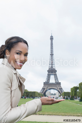 Portrait happy woman gesturing in front of Eiffel Tower, Paris