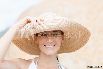 Portrait happy woman in sun hat