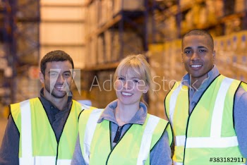 Portrait happy workers in distribution warehouse