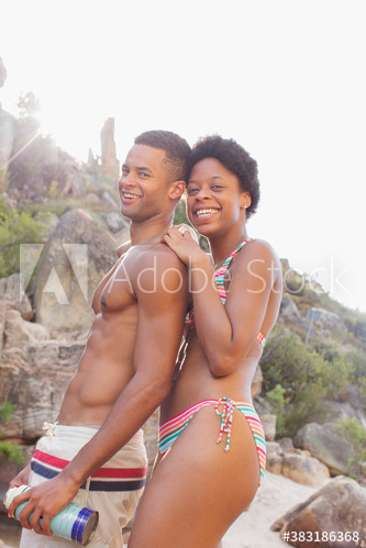 Portrait happy young couple in bathing suits on vacation
