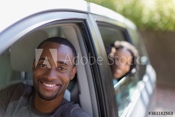 Portrait happy young couple in car