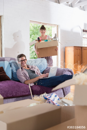 Portrait happy young couple moving into new apartment