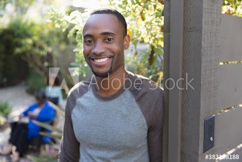 Portrait happy young man on patio