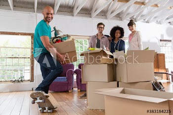 Portrait happy young roommates moving into loft apartment