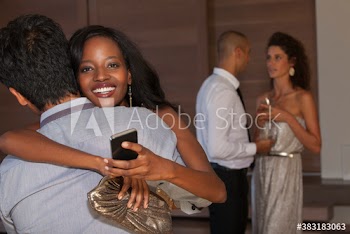 Portrait happy young woman hugging boyfriend at party
