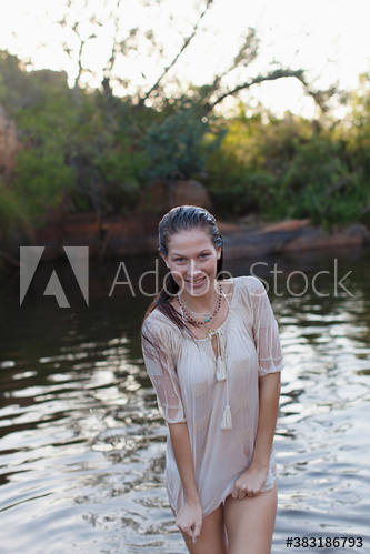 Portrait happy young woman swimming in lake