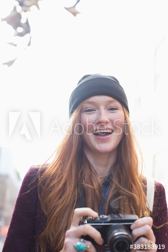 Portrait happy young woman with camera
