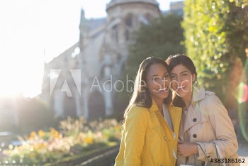 Portrait happy young women friends in sunny park, Paris, France