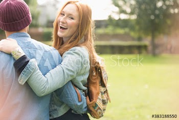 Portrait happy young young woman with boyfriend in park