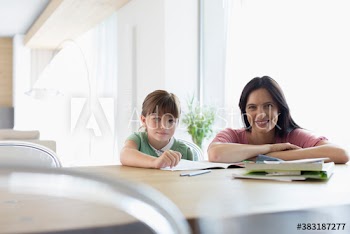 Portrait mother and daughter coloring at dining table