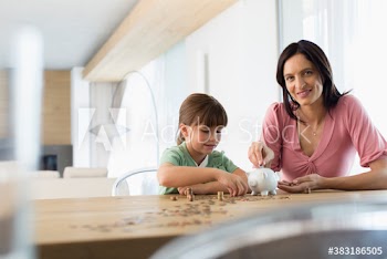 Portrait mother and daughter counting coins from piggybank at table