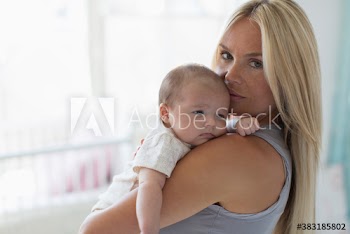 Portrait mother holding baby daughter