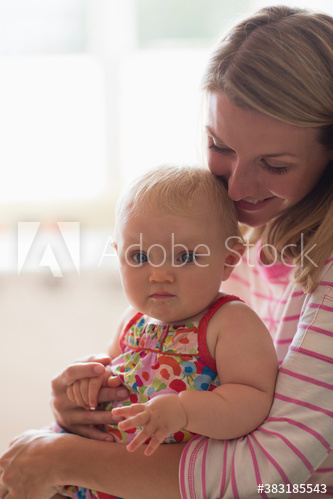 Portrait mother holding cute baby daughter