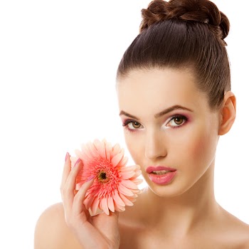 Portrait of a fresh and lovely woman with flower