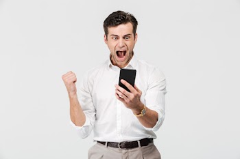 Portrait of a happy satisfied man looking at mobile phone Free Photo