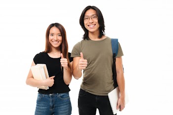 Portrait of a joyful attractive asian students couple Free Photo