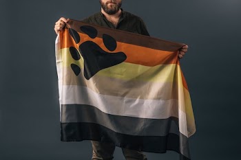 Portrait Of A Man Holding Bear Pride Flag
