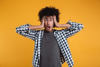 Portrait of a shocked astonished african man Free Photo