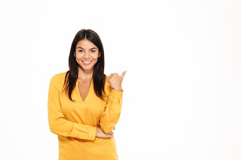 Portrait of a smiling attractive woman pointing finger Free Photo