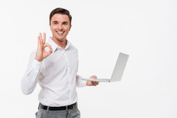 Portrait of a smiling handsome man holding laptop Free Photo