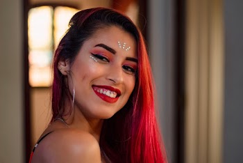 Portrait of a smiling woman with bright red hair 