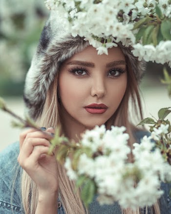 Portrait Of A Woman Behind Flowers