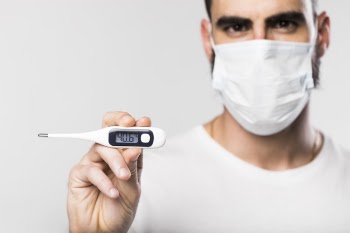 Portrait of adult male holding a thermometer Free Photo